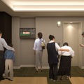 エレベーターホールに同システムの情報を表示するモニターを設置したイメージ。地震発生時に慌てて逃げることで二次災害に巻き込まれる可能性を軽減するシステムとなる（画像はプレスリリースより）