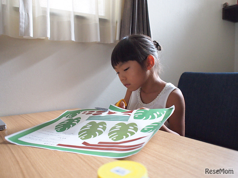 ペーパークラフト用の素材を切り始める子ども