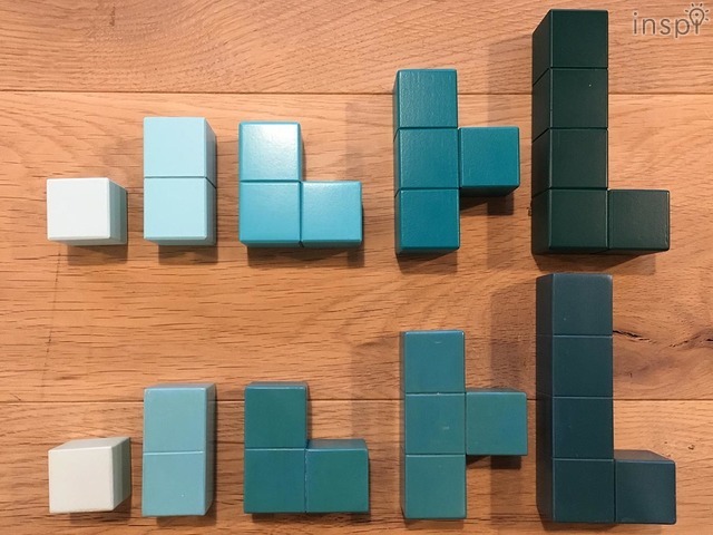 上は国内工場でつくったもので、溝がきれいに彫られグラデーションも均等で美しい。下は海外で試作したもの。3個のパーツと4個のパーツで色が近い。　◆コクヨの積み木『Kizuki no Ki』