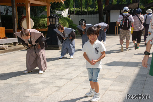 門の前で「がんばるぞ！」と黎くん
